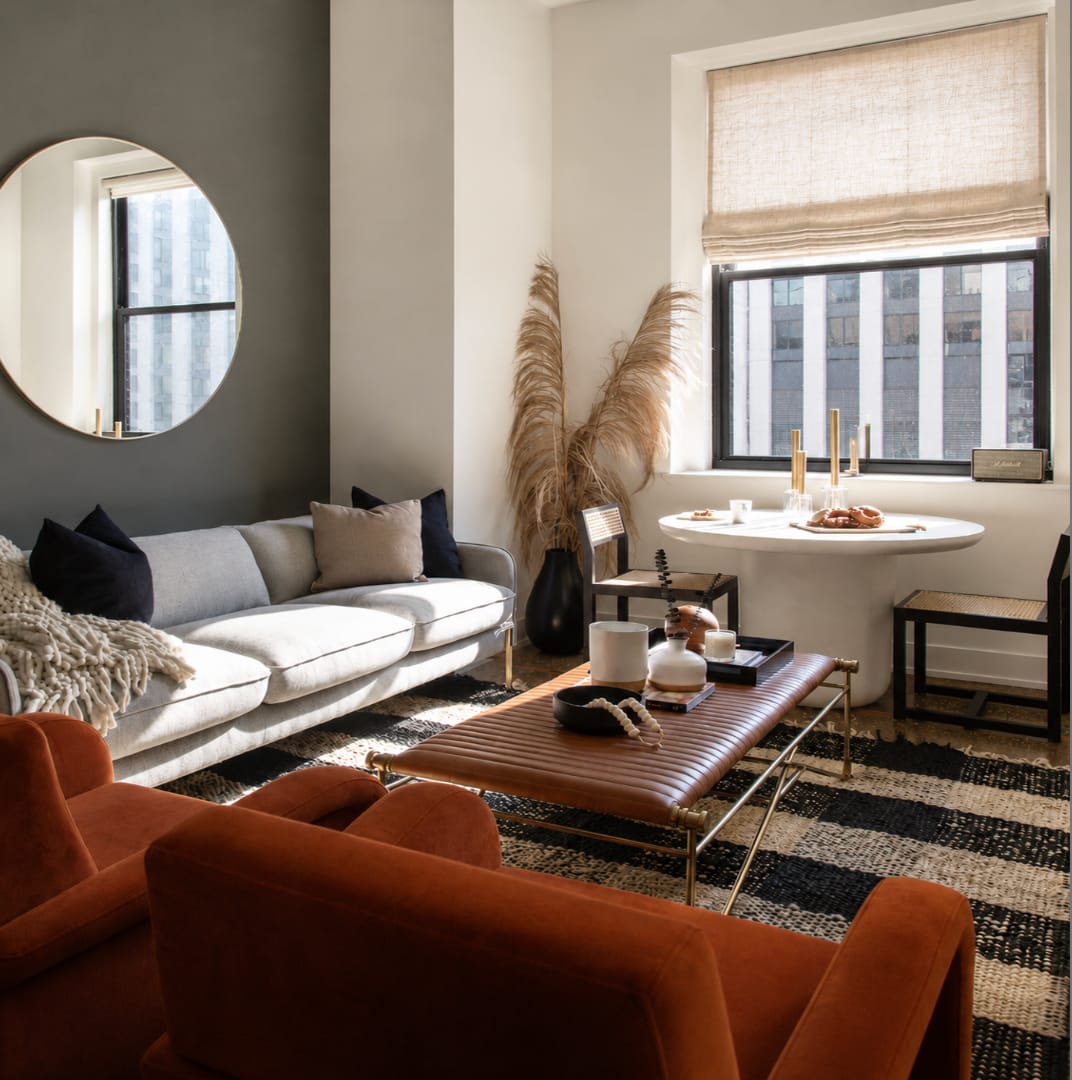 Living room of a furnished Blueground apartment with a sofa, dining table and city view
